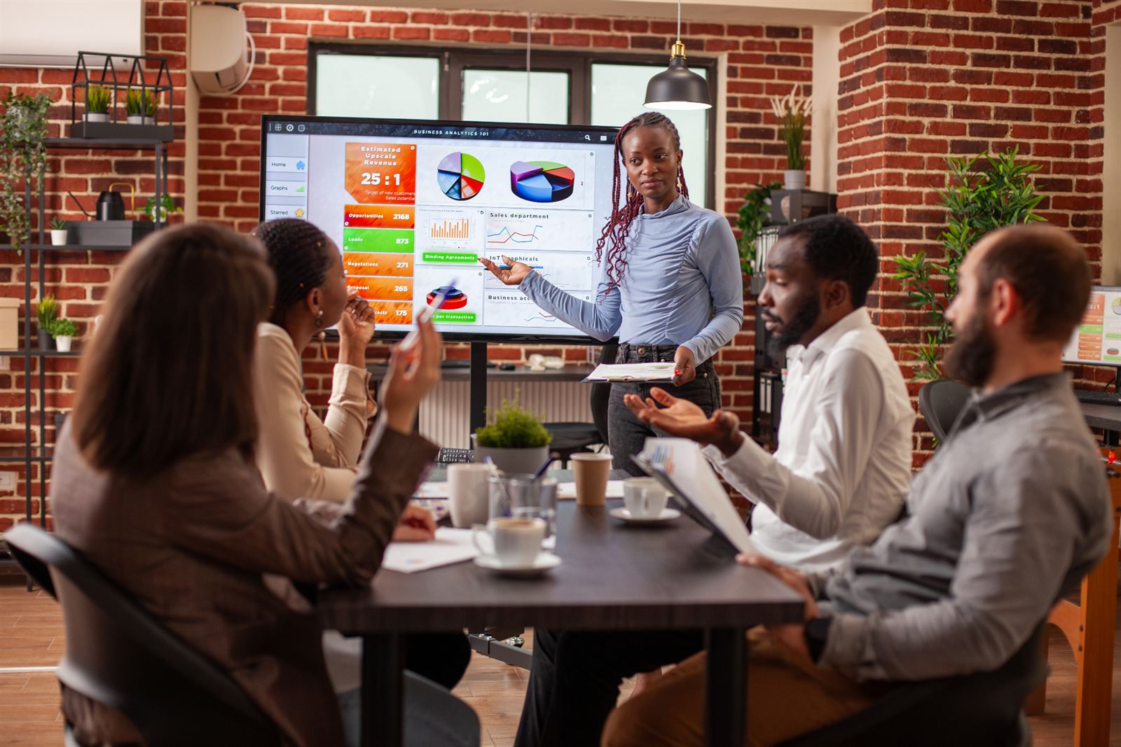A team collaborating around a laptop
